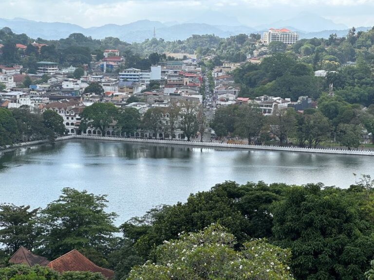 Aerial view of Kandy city with lush greenery and tranquil Kandy Lake in Sri Lanka.