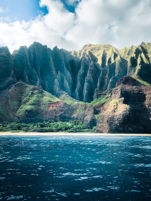 Explore the stunning Na Pali Coast with dramatic cliffs and pristine ocean views in Kauai, Hawaii.