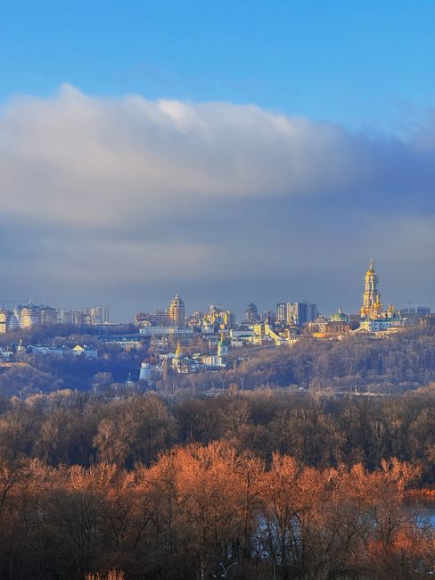 Breathtaking skyline view of Kyiv, Ukraine capturing iconic landmarks under a vibrant sky.