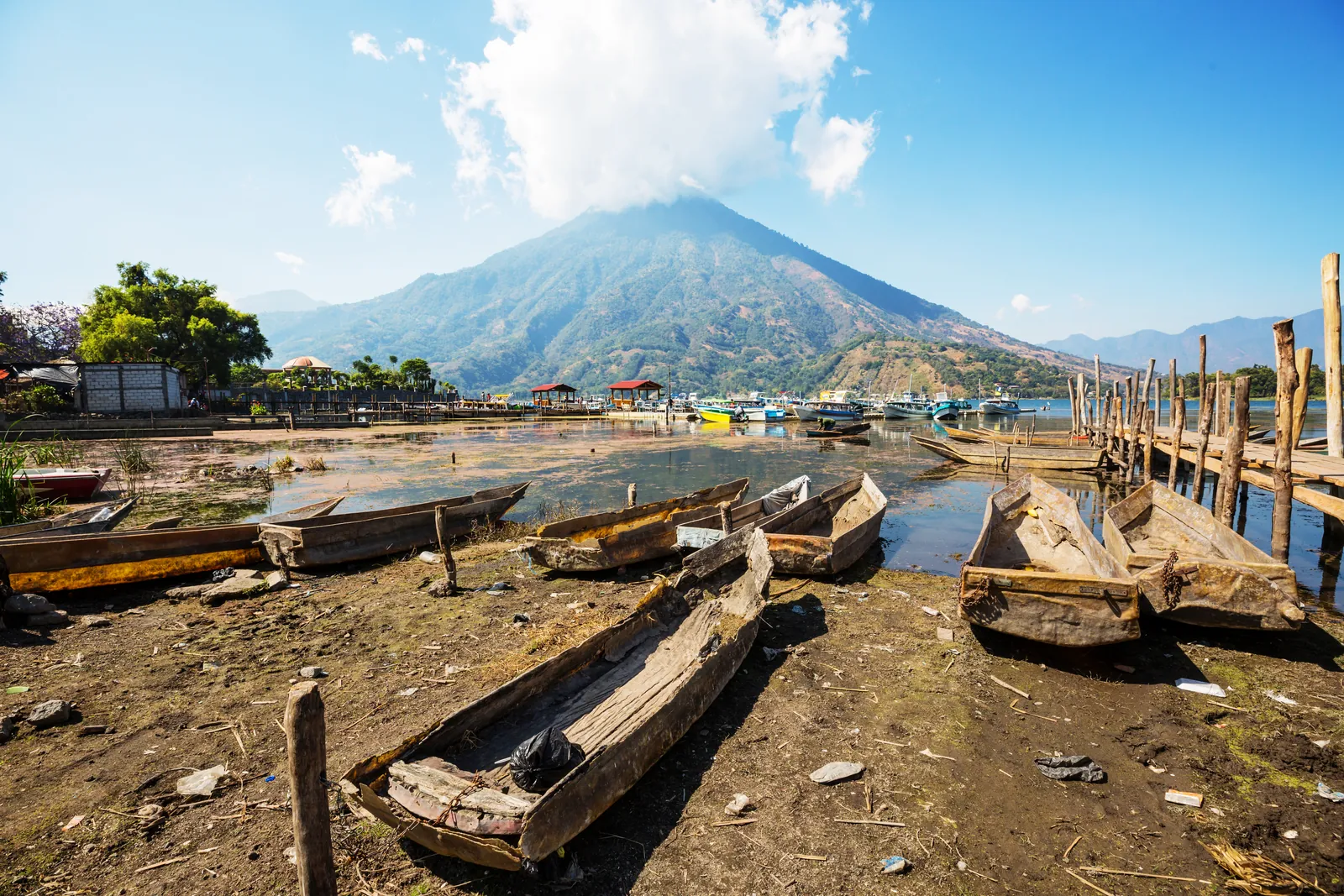 Wooden boats on Lake Atitlán with the volcanoes behind, Guatemala