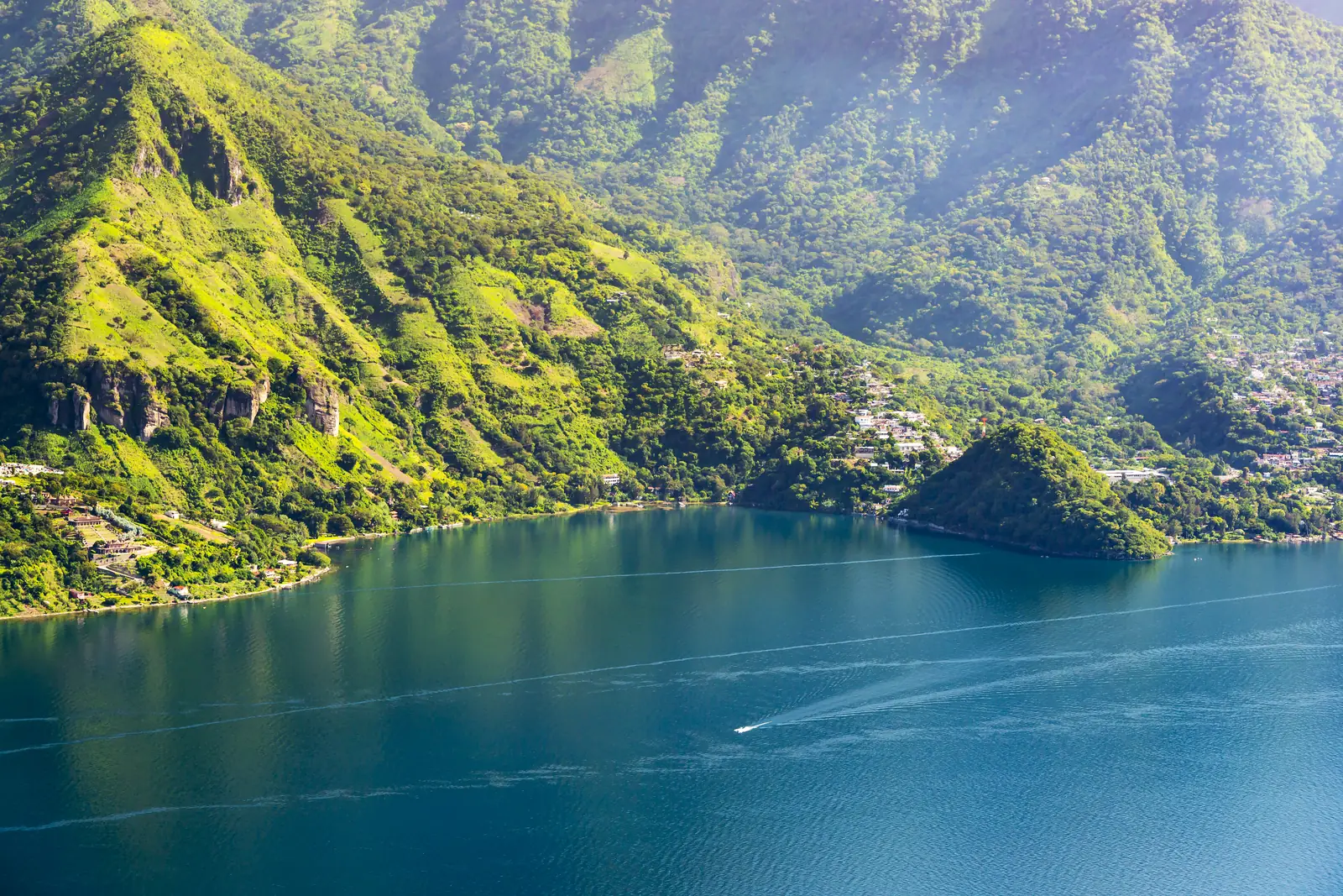 Green volcanoes around the turquoise water of Lake Atitlán, Guatemala