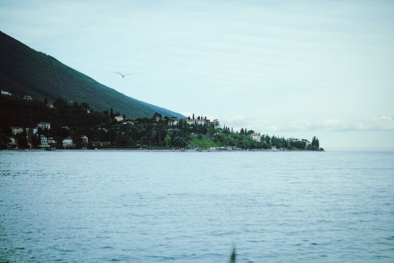 Picturesque landscape of Lake Garda with a distant island under a summer sky.