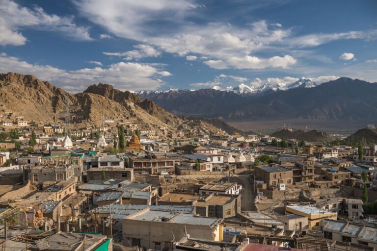 Stunning aerial view of Leh city with rugged mountains and clear blue skies in Ladakh, India.