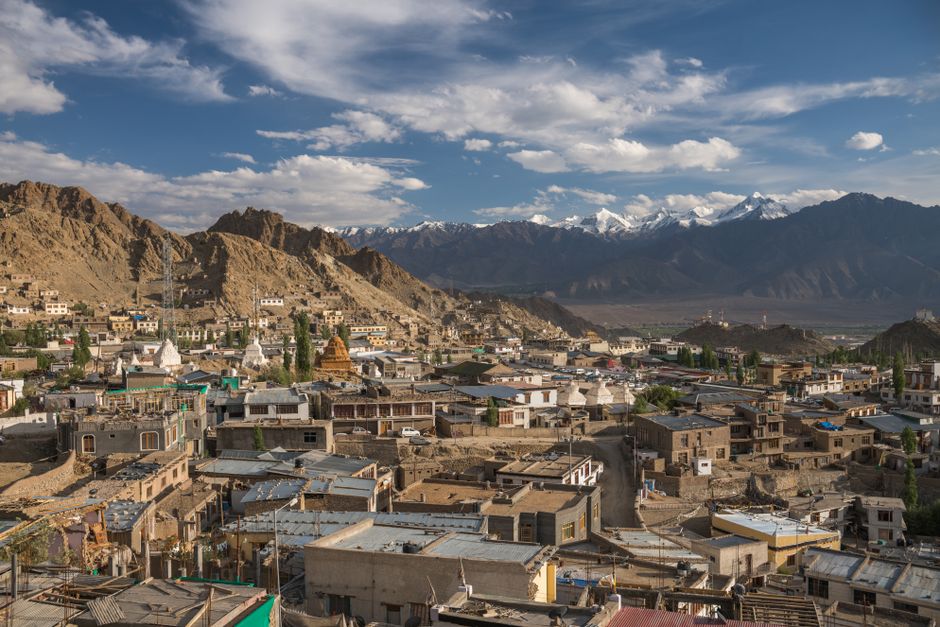 Stunning aerial view of Leh city with rugged mountains and clear blue skies in Ladakh, India.