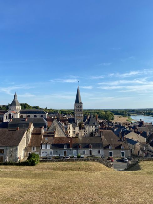 Quaint village La Charité-sur-Loire with church and rooftops under blue sky.