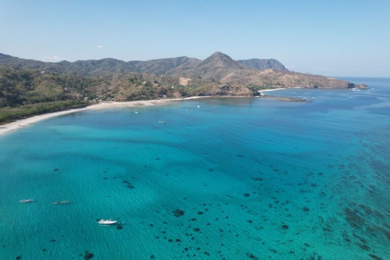 A breathtaking aerial view of the clear turquoise waters and coastline of Lombok, Indonesia.