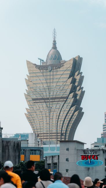 The iconic Grand Lisboa Hotel Casino towering above the busy streets of Macau.