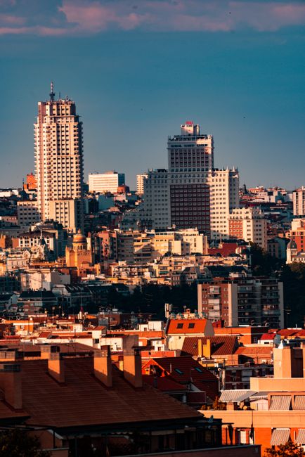 Cityscape of Madrid showcasing iconic skyline during golden hour with vibrant urban aesthetic.