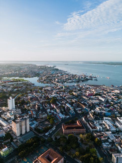 Stunning aerial view of Manaus city and coastline, showcasing urban architecture and vibrant waterways.