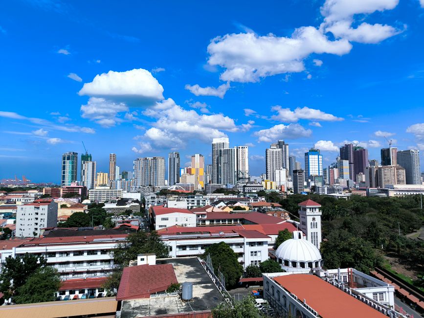 Stunning aerial shot of Manila's skyline under a clear blue sky, capturing urban architecture.