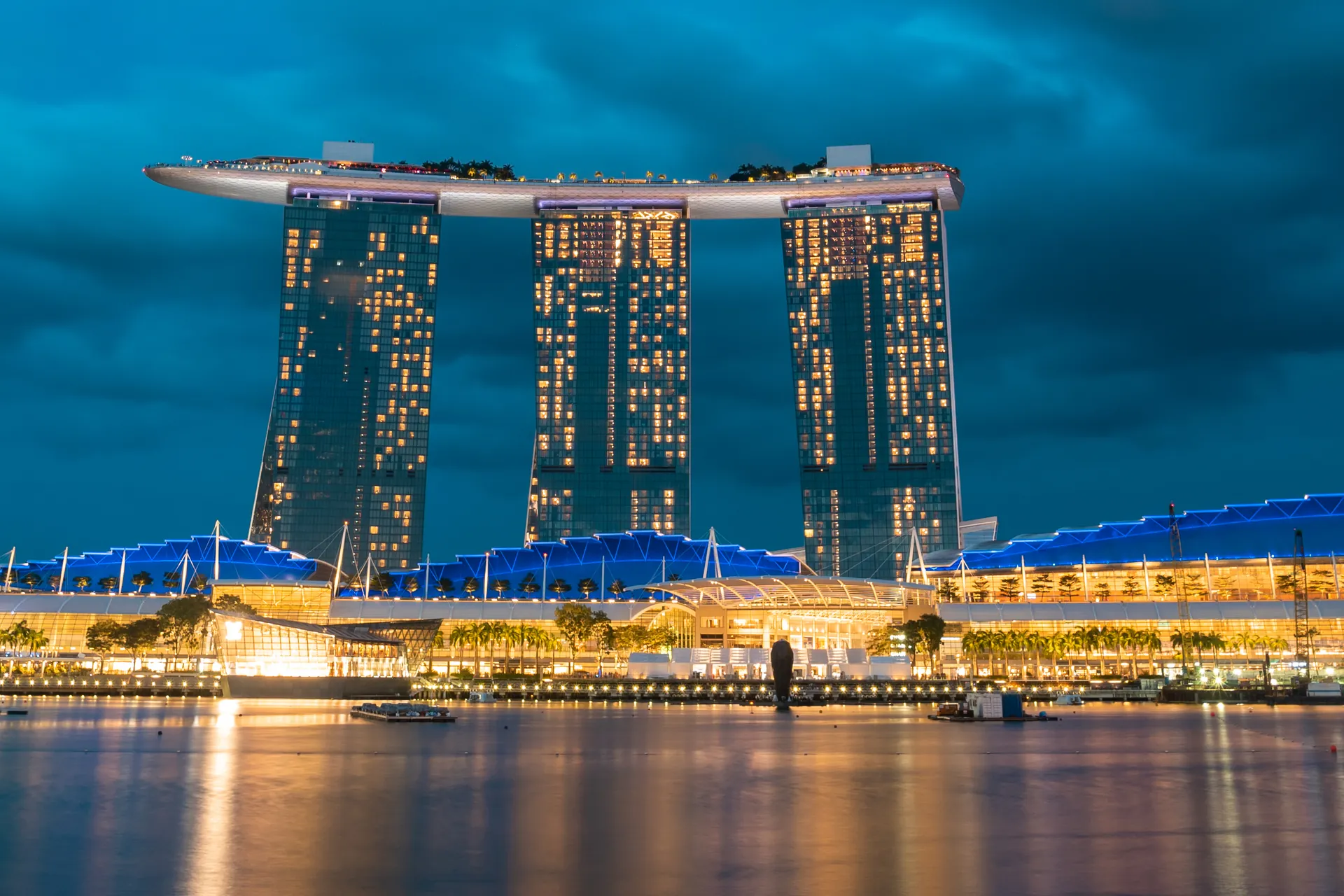 Marina Bay Sands lit up at night across the water of Marina Bay, Singapore