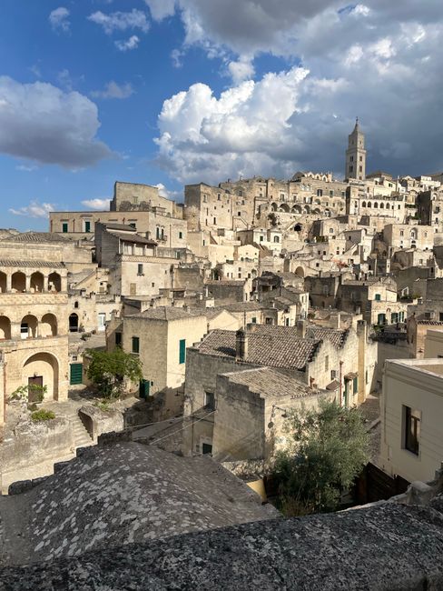 View of the ancient stone dwellings of Matera's Sassi under a dramatic sky.