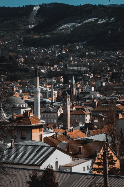 Explore Sarajevo's skyline featuring minarets, urban architecture, and scenic hills.