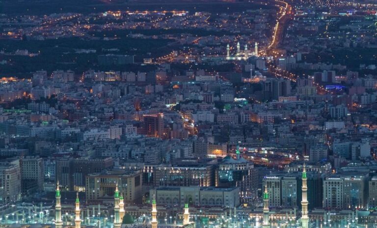 Aerial view of contemporary big metropolis illuminated with glowing city lights at night
