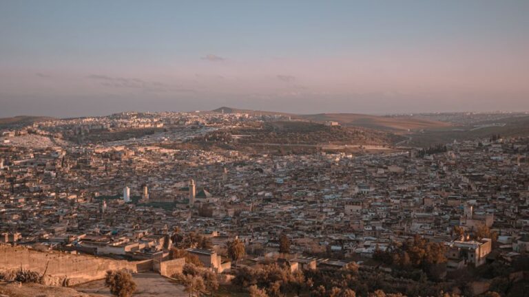 Stunning aerial view of Fes, Morocco showcasing the city's expansive cityscape at sunset.