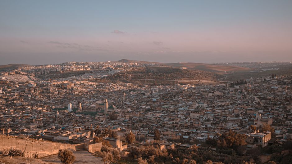 Stunning aerial view of Fes, Morocco showcasing the city's expansive cityscape at sunset.