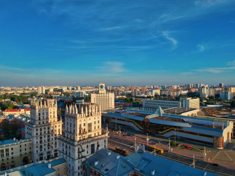 Stunning aerial view of Minsk featuring iconic buildings against a bright blue sky.