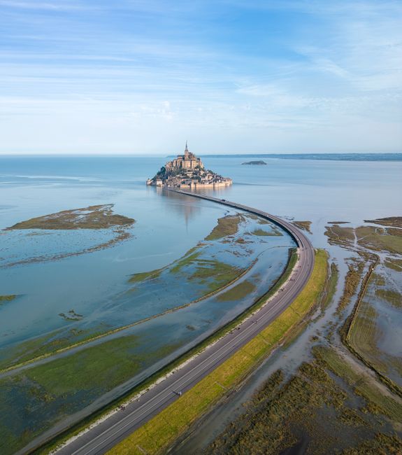 A breathtaking aerial shot of Mont Saint-Michel in Normandy, France, surrounded by the sea.