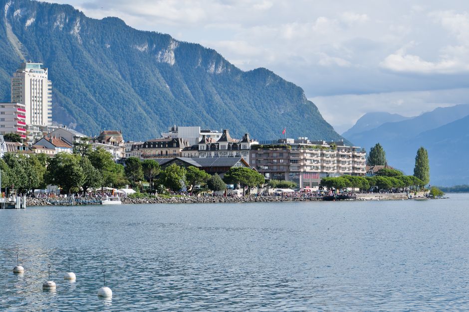 Beautiful view of Montreux's waterfront with the Swiss Alps in the background, highlighting Lake Geneva.