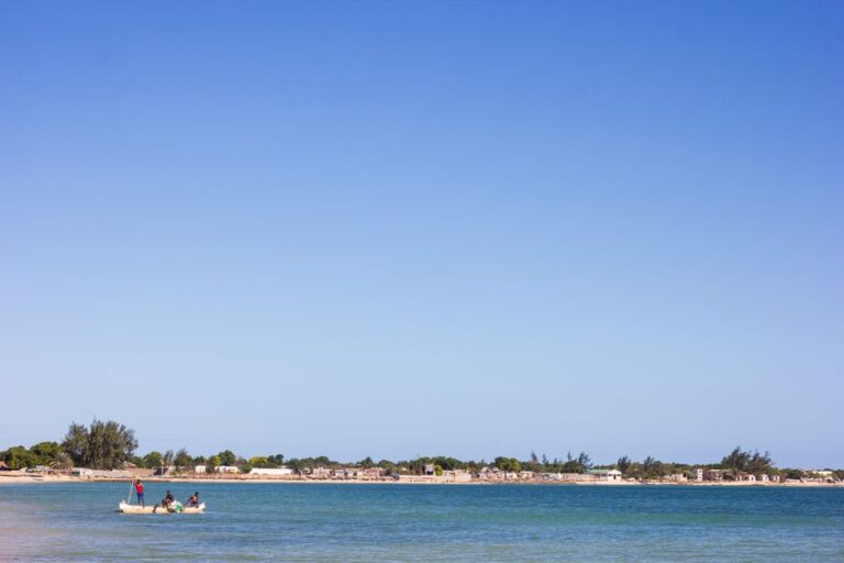 Peaceful scene of a dugout canoe on Ifaty beach, Madagascar under clear blue skies.
