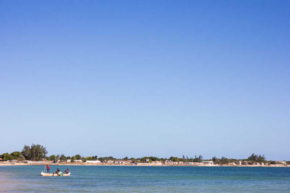Peaceful scene of a dugout canoe on Ifaty beach, Madagascar under clear blue skies.