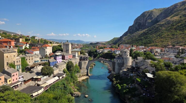 Explore the historic Old Bridge in Mostar, Bosnia and Herzegovina, surrounded by picturesque architecture.