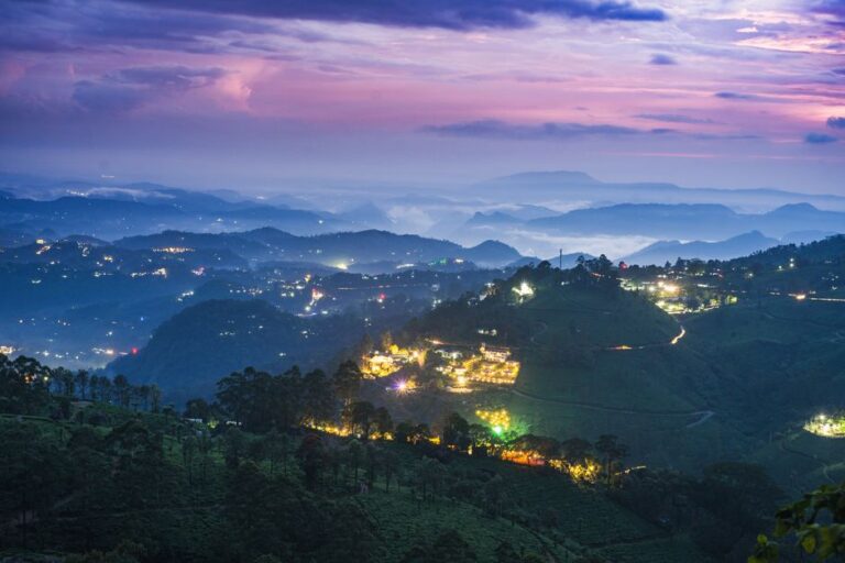 Stunning twilight landscape of illuminated hills in Munnar, Kerala, India.