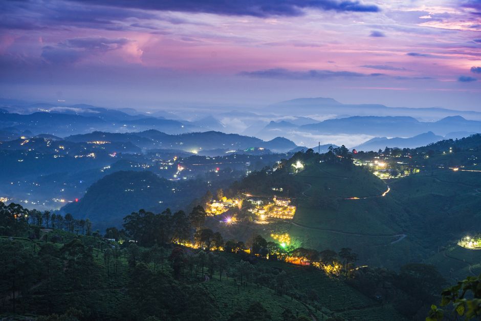 Stunning twilight landscape of illuminated hills in Munnar, Kerala, India.