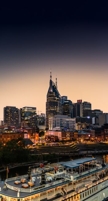 Stunning view of Nashville's skyline at dusk featuring recognizable skyscrapers and waterfront.