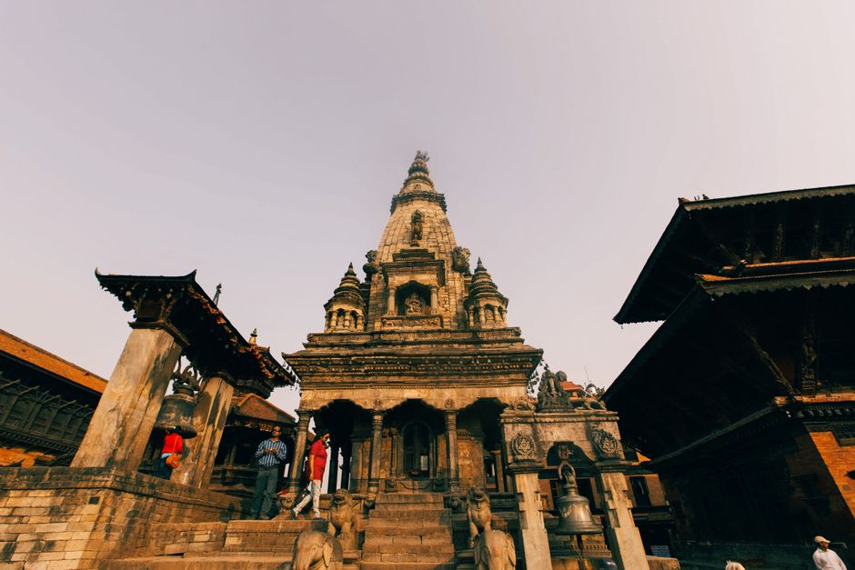 Low angle view of a historic temple at Bhaktapur Durbar Square, showcasing intricate carved architecture.