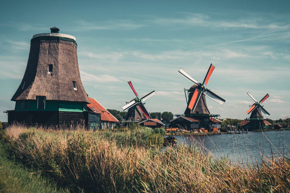 Scenic view of traditional windmills at Zaanse Schans, showcasing Dutch heritage.