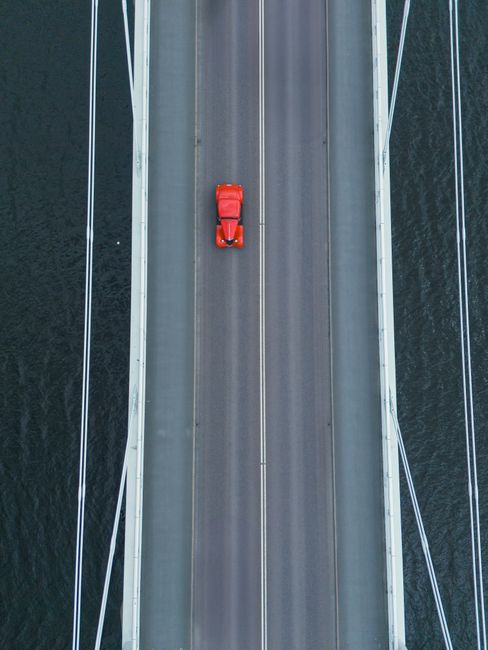 Aerial photo of a red car driving over a bridge in Jönköping, Sweden.