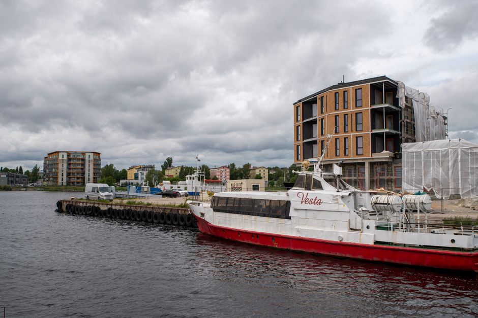 Modern architecture and a passenger ship on the Pärnu River, Estonia.