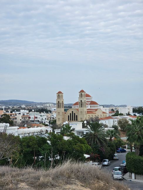 Aerial view of Paphos, Cyprus featuring the Agioi Anargyroi Church against a cloudy sky.