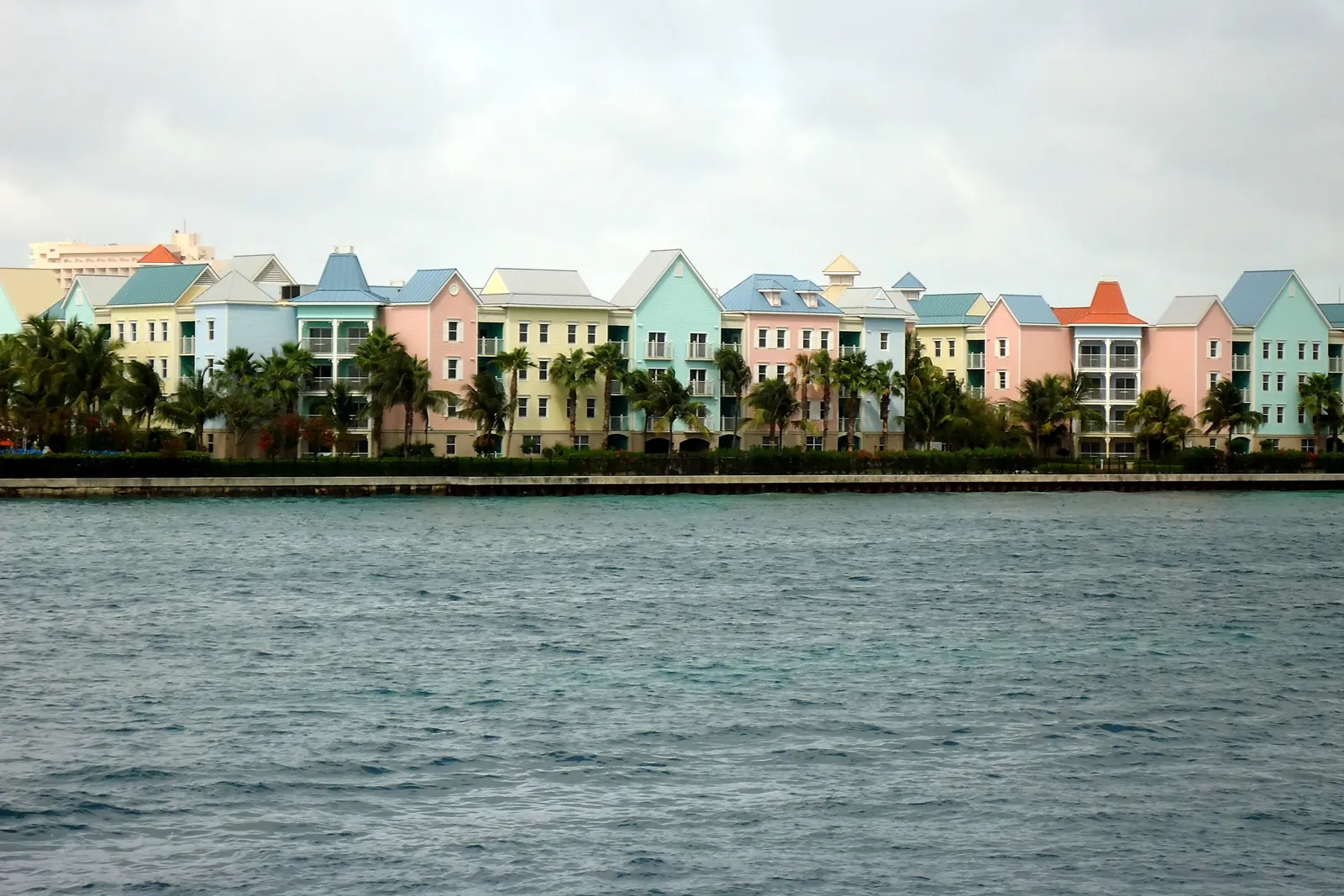 Pastel houses all in a row on the water in the Bahamas