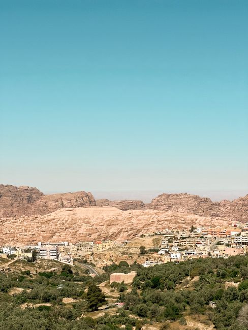 A captivating view of Wadi Musa with rugged cliffs and the town in Ma'an, Jordan.