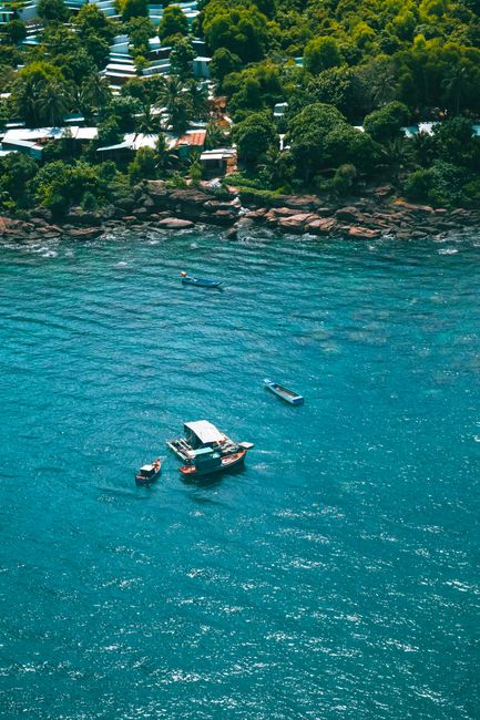 Aerial view of boats on the blue waters off the coast of Phu Quoc, Vietnam.