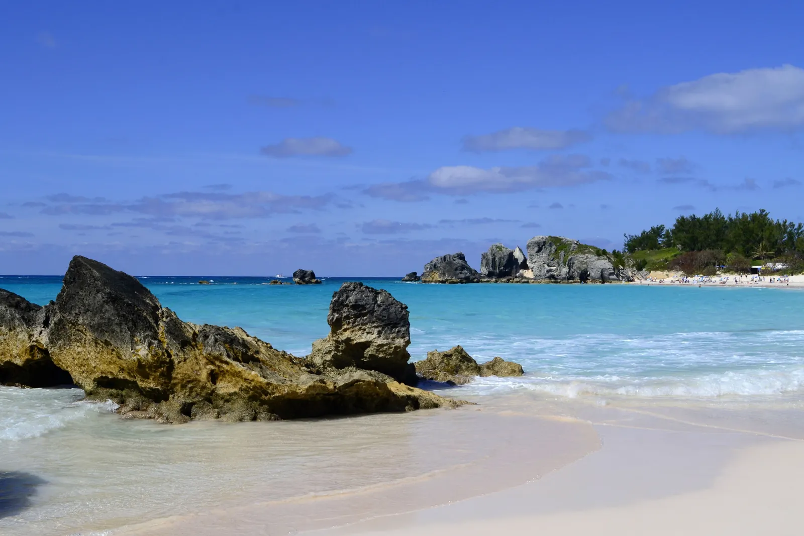 Rocks and pinks sand leading down to the clear blue waters off the coast of the island of Bermuda