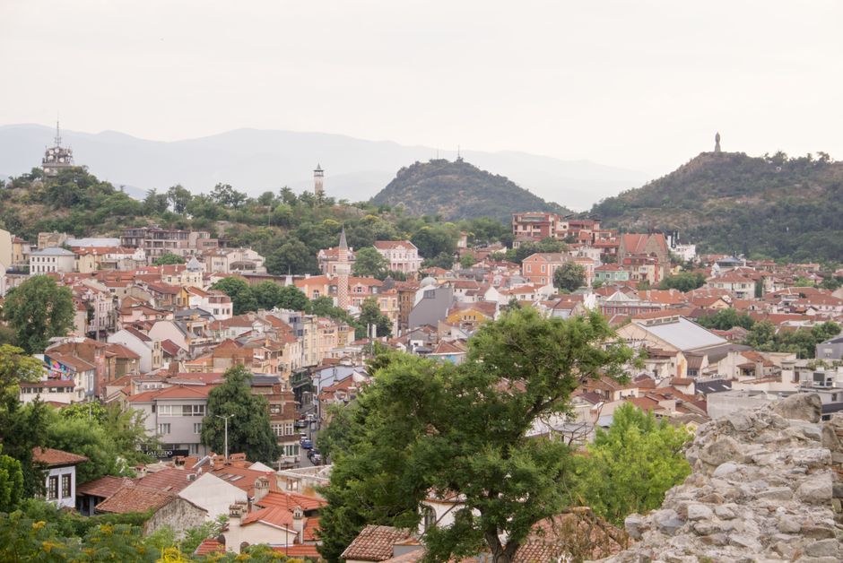 Explore the charming architecture and historic sites of Plovdiv's old town with hills in the backdrop.