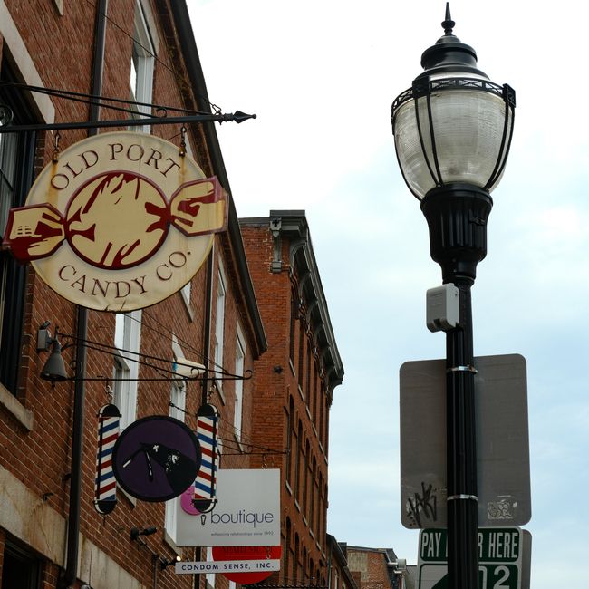 Street scene featuring rustic buildings and a vintage lamp in urban setting.