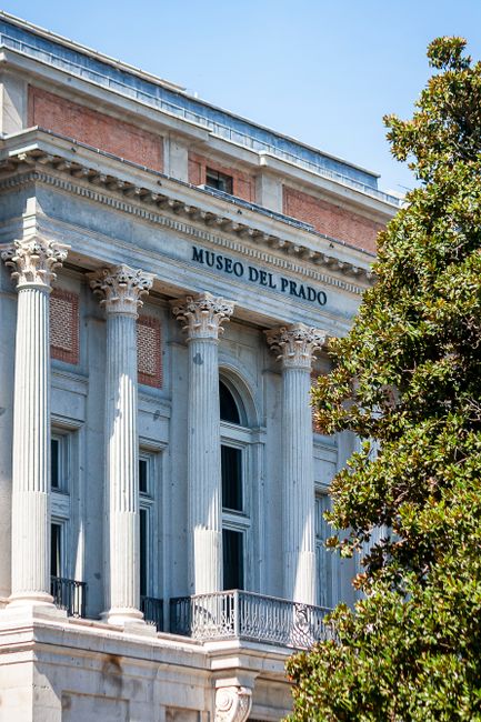 Elegant neoclassical facade of Museo del Prado in Madrid on a sunny day.