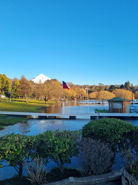A serene scene of a lake with the majestic Osorno Volcano in the background, viewed from Puerto Varas, Chile.