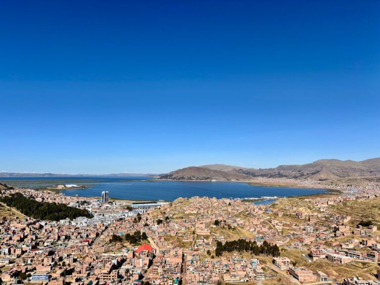 Aerial view of Puno city with Lake Titicaca in the background, showcasing stunning Peruvian landscapes.