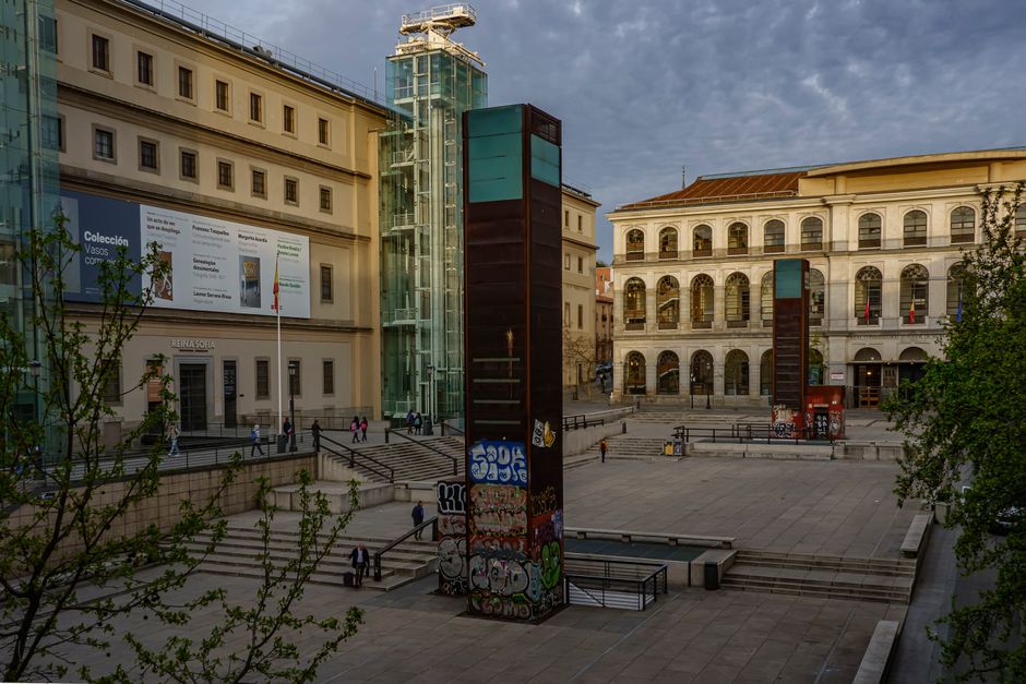 Early evening view of the Reina Sofia Museum entrance in Madrid, showcasing modern architecture.