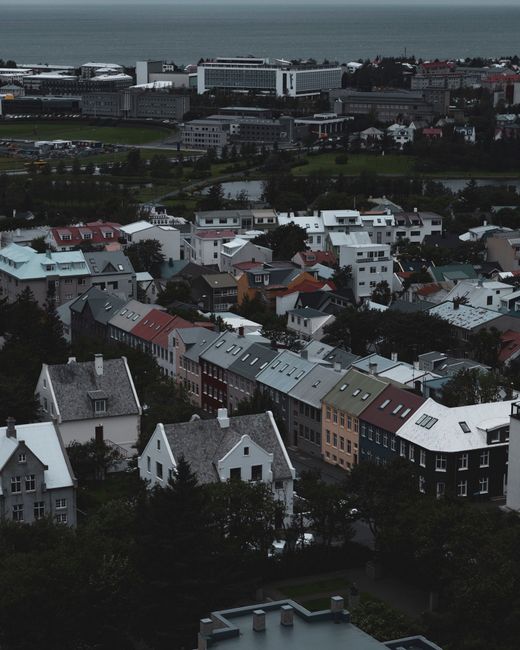Colorful rooftops and urban landscape captured over Reykjavík, Iceland.