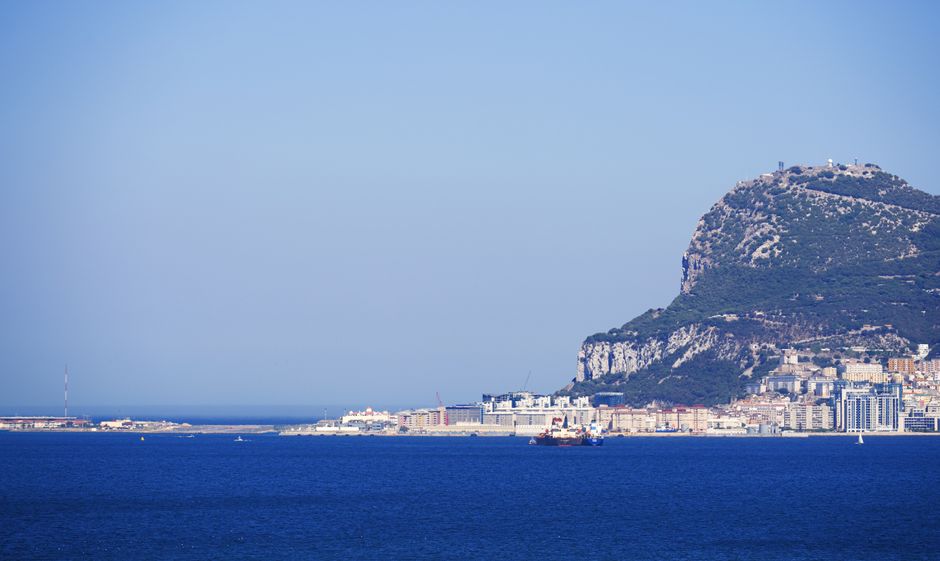 Scenic view of the iconic Rock of Gibraltar, with clear blue sky and sea, ideal for travel imagery.
