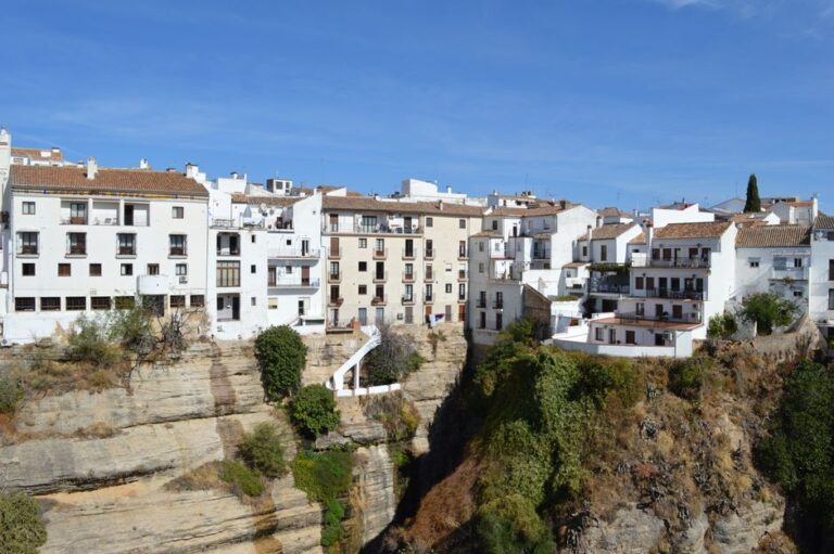 Beautiful whitewashed buildings perched on a cliff in Ronda, Andalusia, Spain. A stunning travel destination.