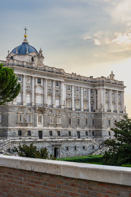 Stunning facade of a grand neo-classical palace at sunset, highlighting architectural intricacy.
