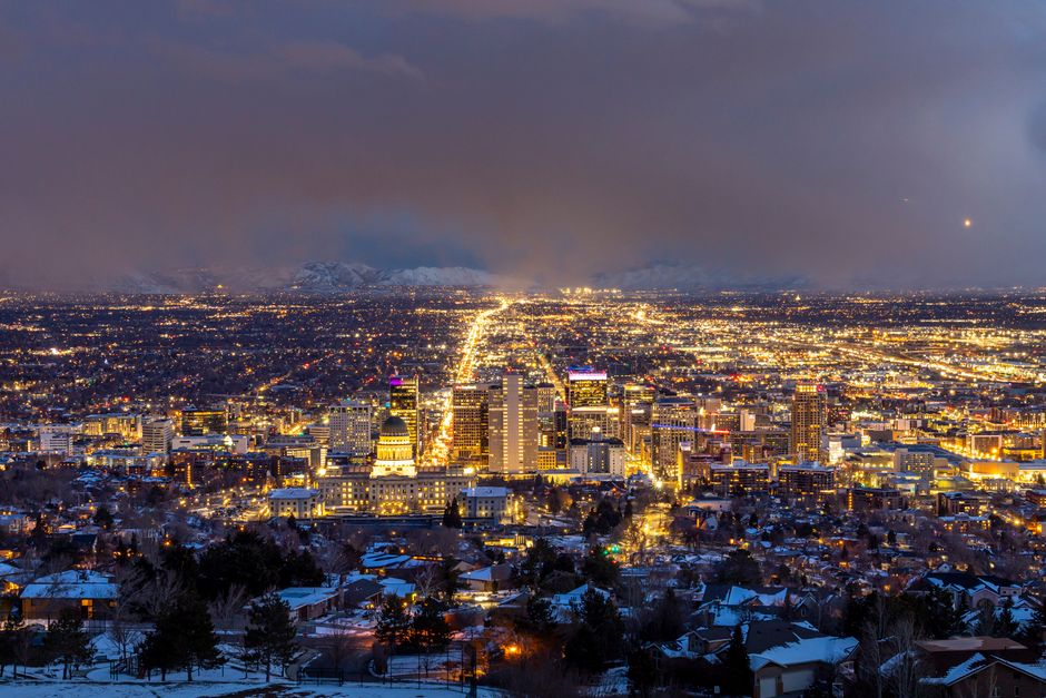 A breathtaking aerial view of Salt Lake City illuminated at night, showcasing its urban beauty.