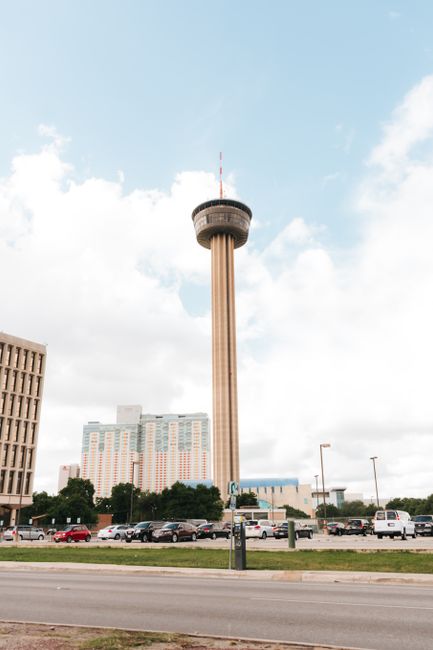 A view of the Tower of the Americas against the San Antonio skyline on a sunny day.